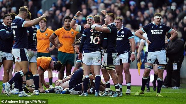 92468973-14124547-Scotland_players_celebrate_at_full_time_after_their_win_over_Aus-m-11_173256255730.jpeg