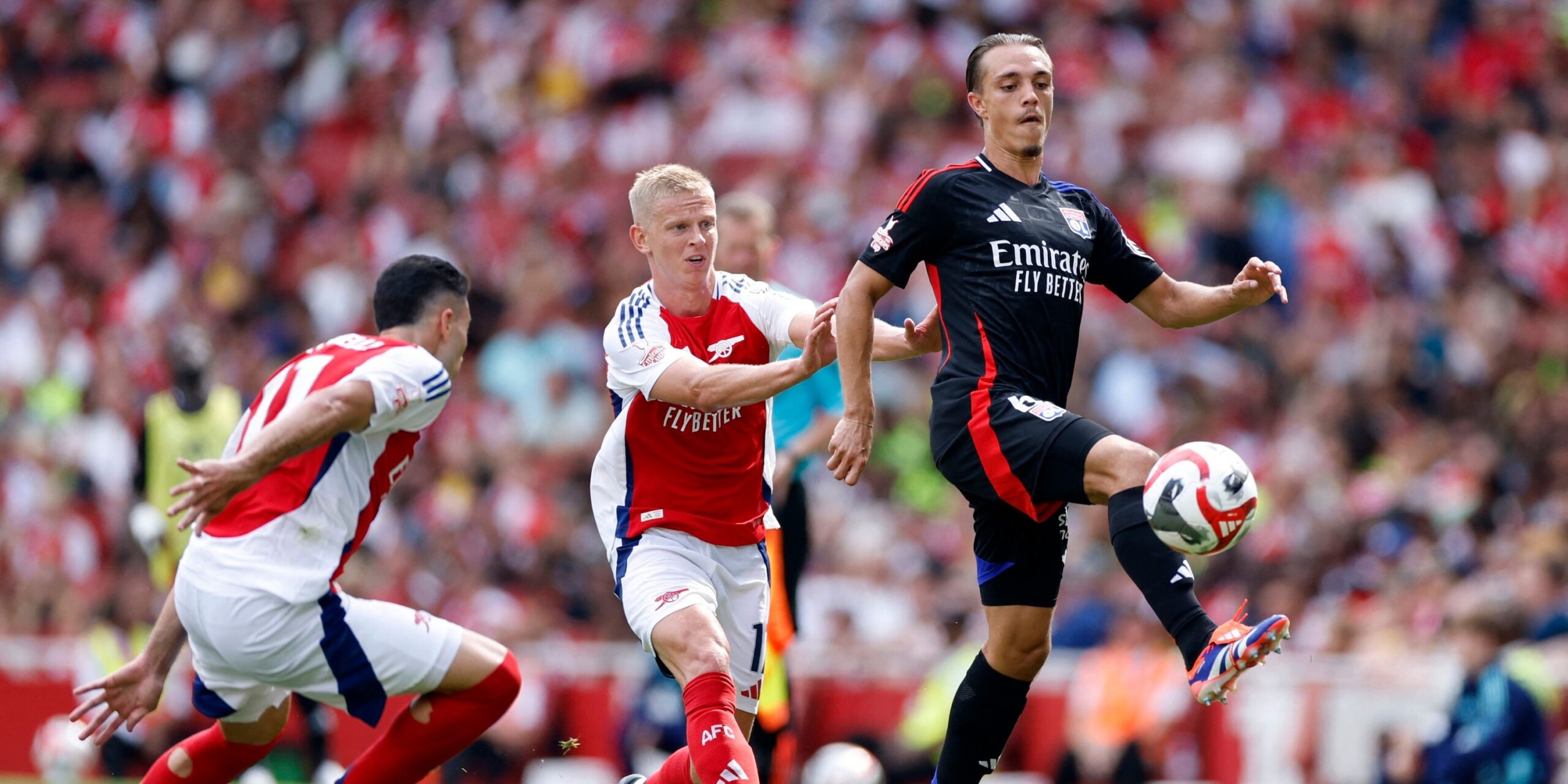 olympique-lyonnais-maxence-caqueret-in-action-with-arsenal-s-oleksandr-zinchenko-and-gabriel-martine.jpeg
